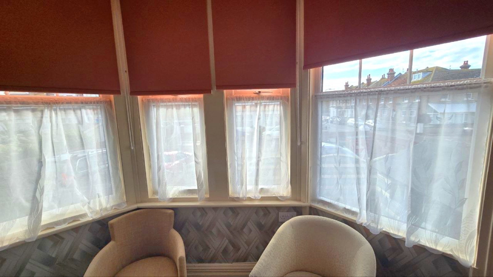 Room 1 · Jade — bay window seating with twin beds beyond