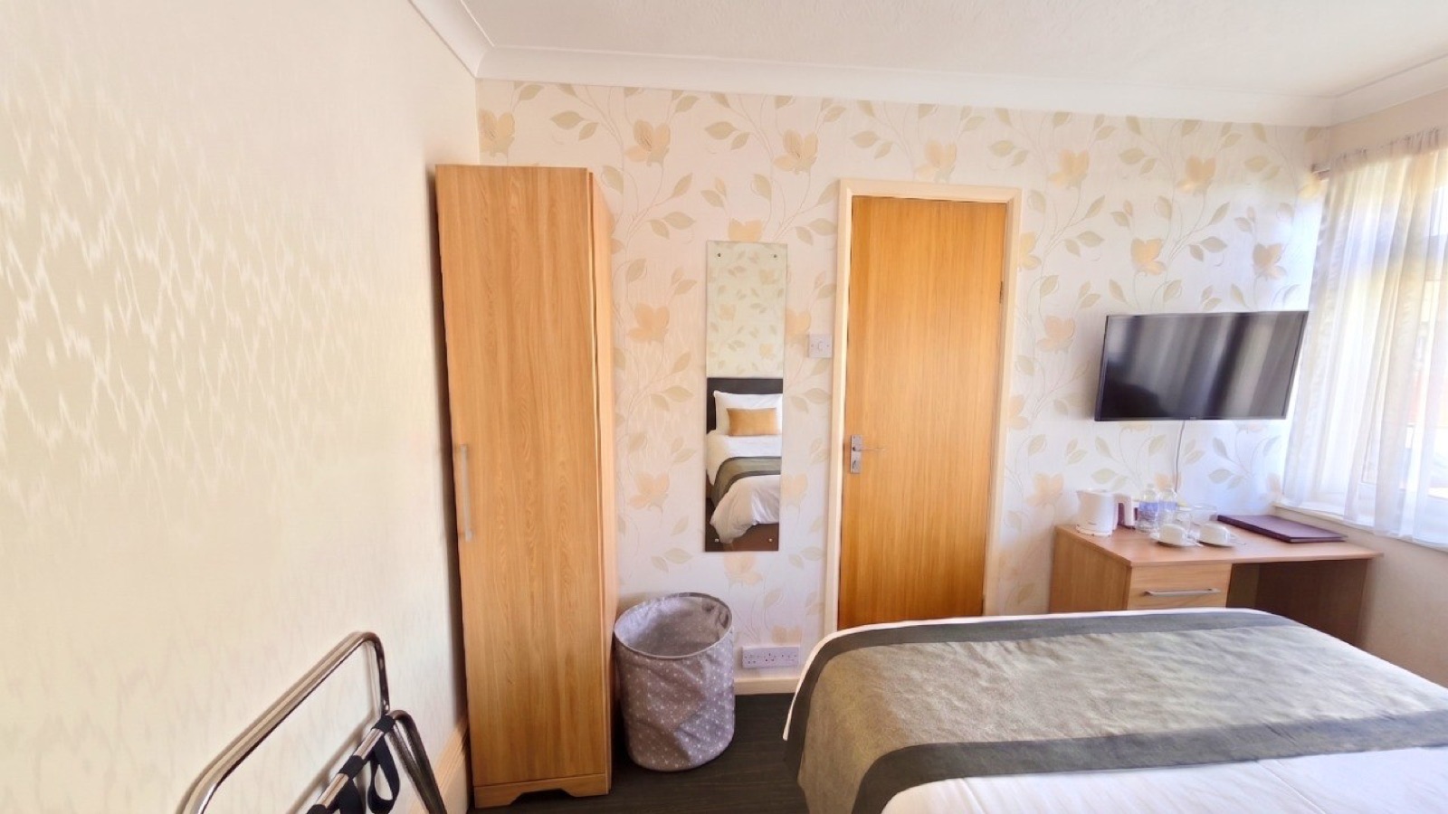 Room 2 · Amber — double bed with TV and wardrobe