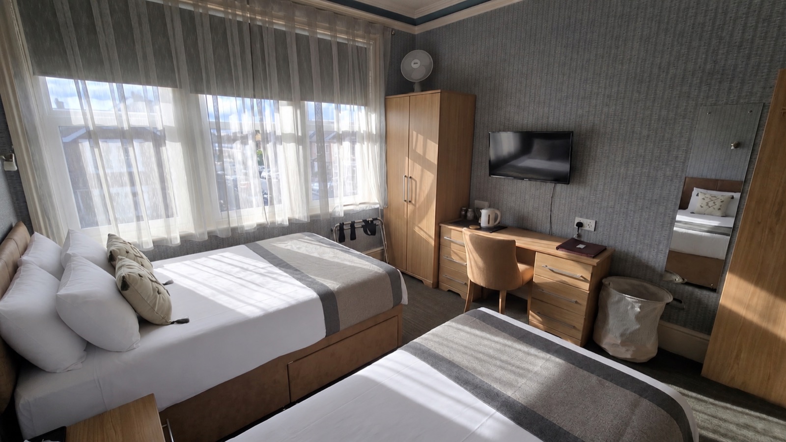 Room 3 · Tourmaline — twin beds with desk and TV